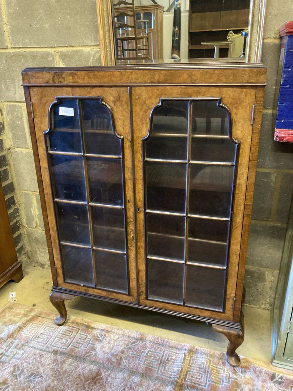 A 1920s Queen Anne revival bookcase, width 78cm, depth 26cm, height 108cm